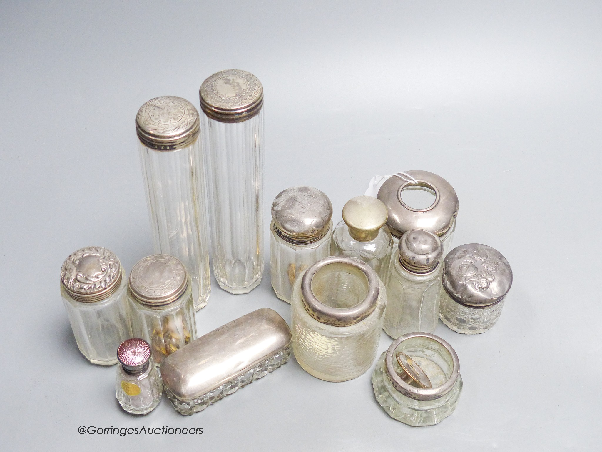 A group of assorted silver topped toilet jars, largest 17cm.